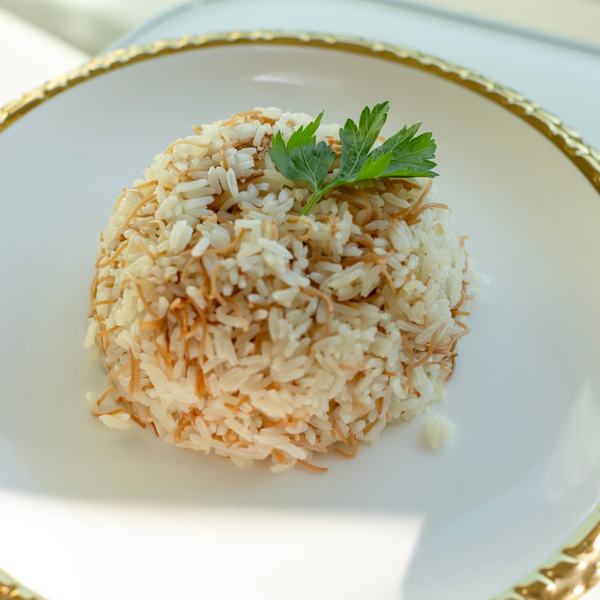 Angel hair jasmine rice on a gold-rimmed plate