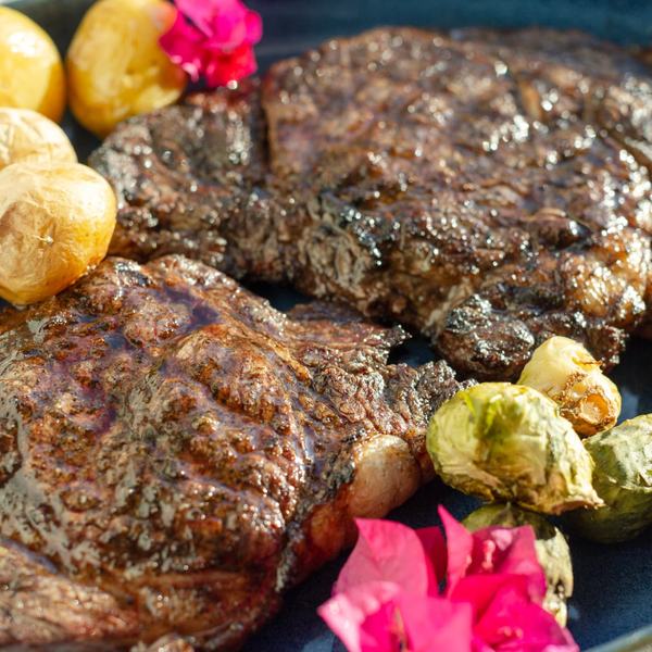 Grilled steaks with roasted baby potatoes and brussels sprouts